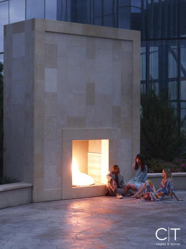 A group of people sitting in front of a fireplace that says cit on the bottom