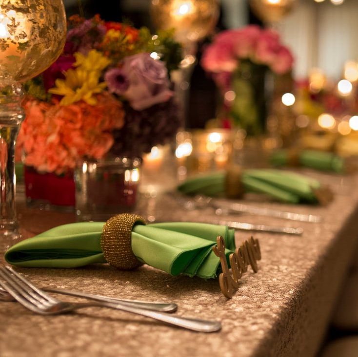 A table setting with green napkins and a name tag that says ' brian '