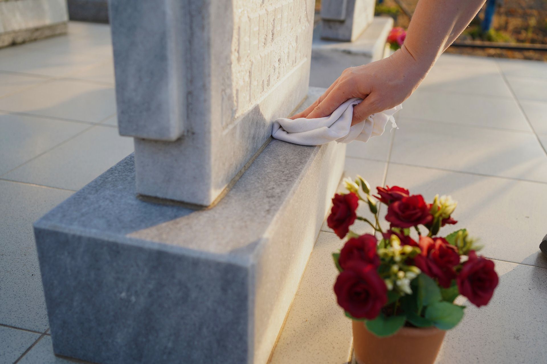 An elderly couple is sitting on a couch looking at a laptop computer.