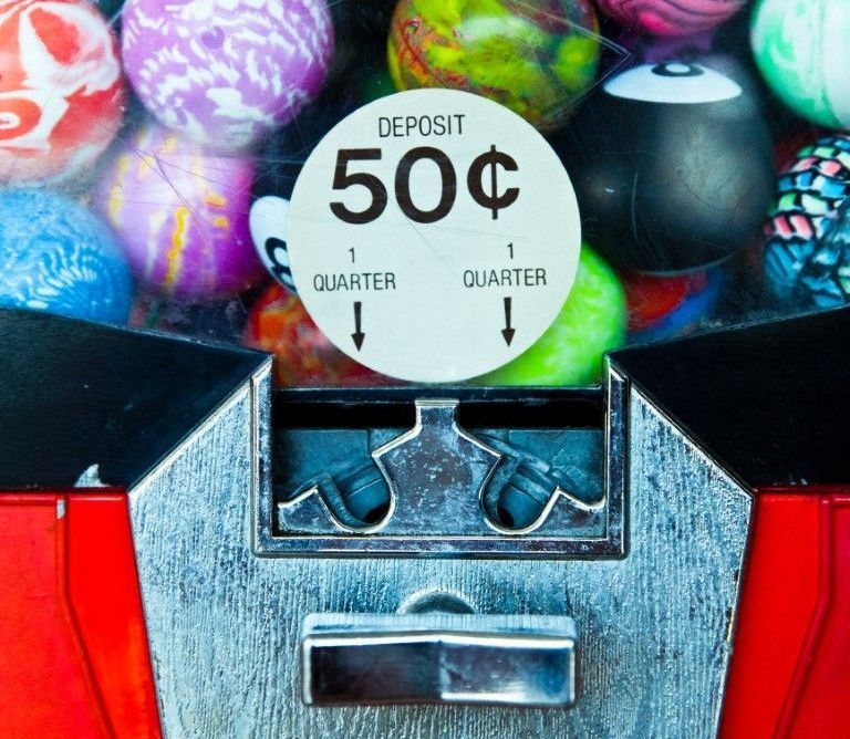 A colorful concession gumball machine filled with assorted candies.