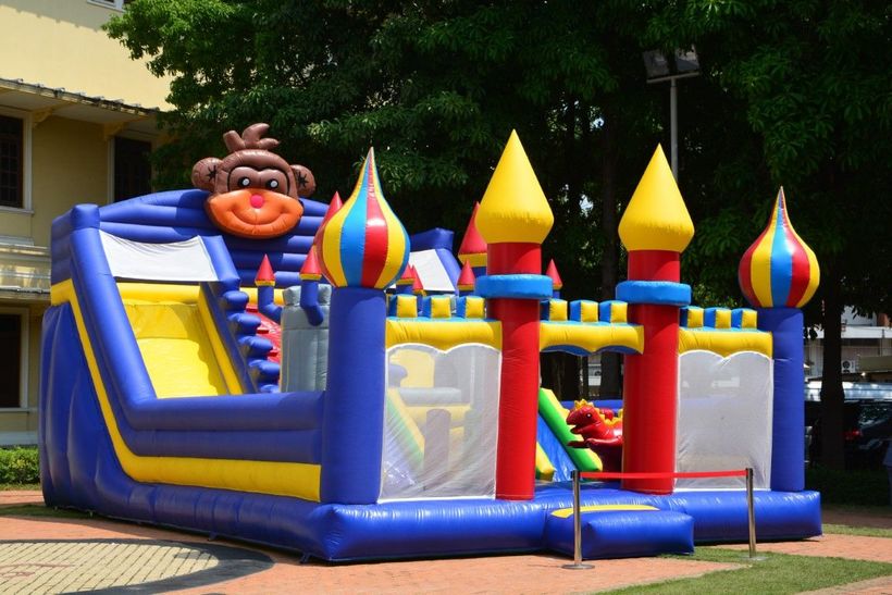 Bounce house with double slides and central stairs, perfect for endless fun.