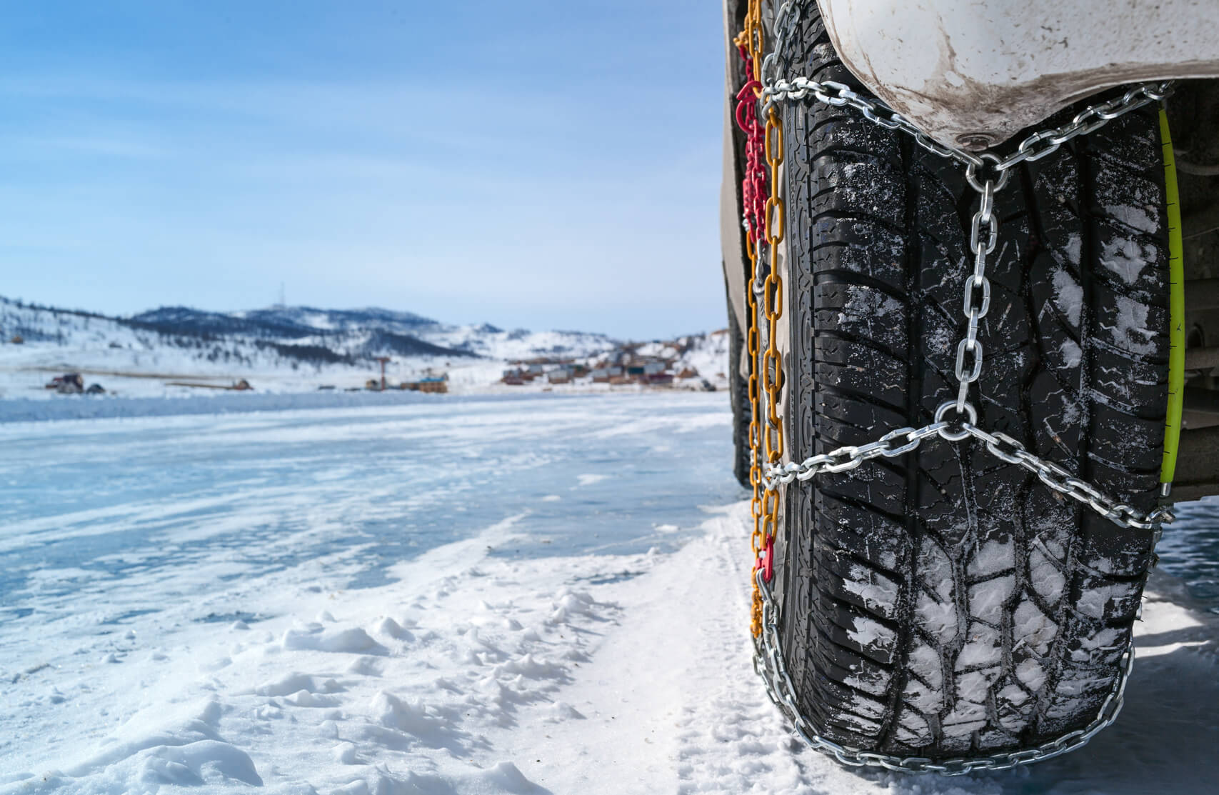 Car tie with chains on it in while driving to a mining site in the snow