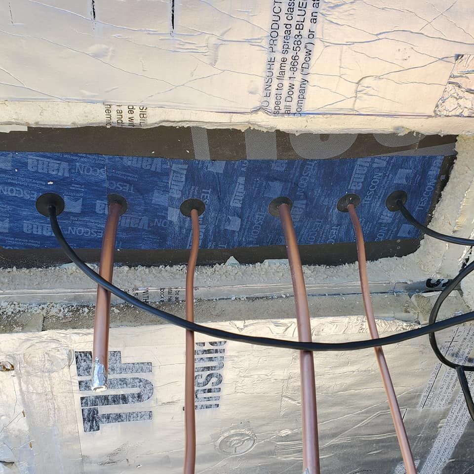 Several copper pipes are connected to a piece of insulation