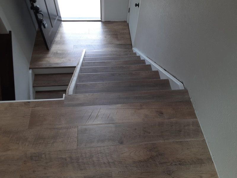 A wooden staircase leading up to the second floor of a house