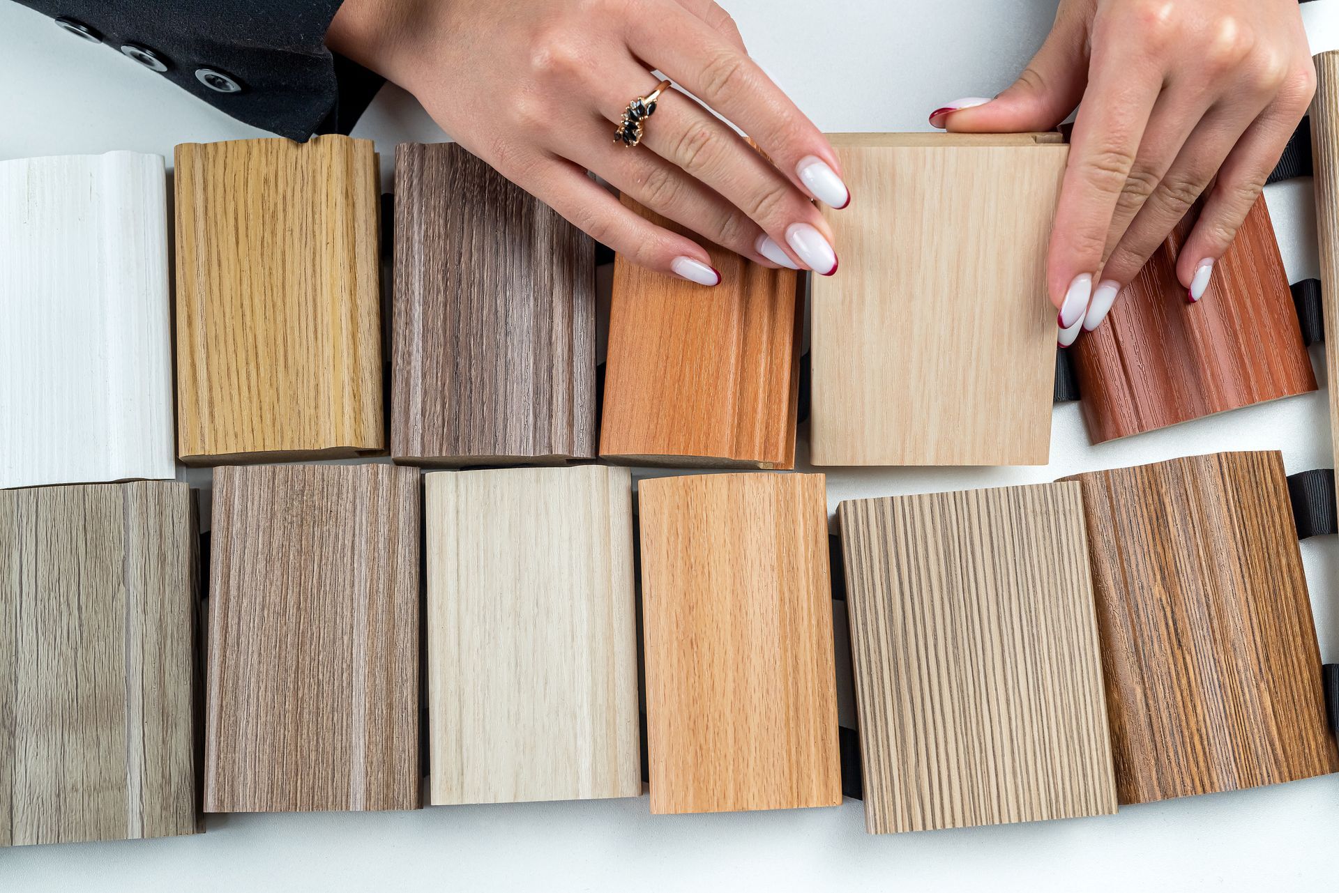 A woman is looking at different types of wood samples.