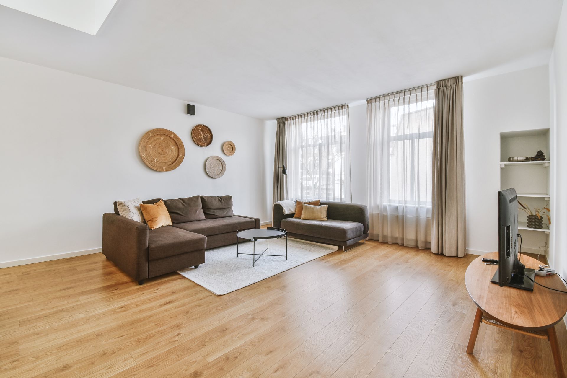 A living room with a couch , table , and television.