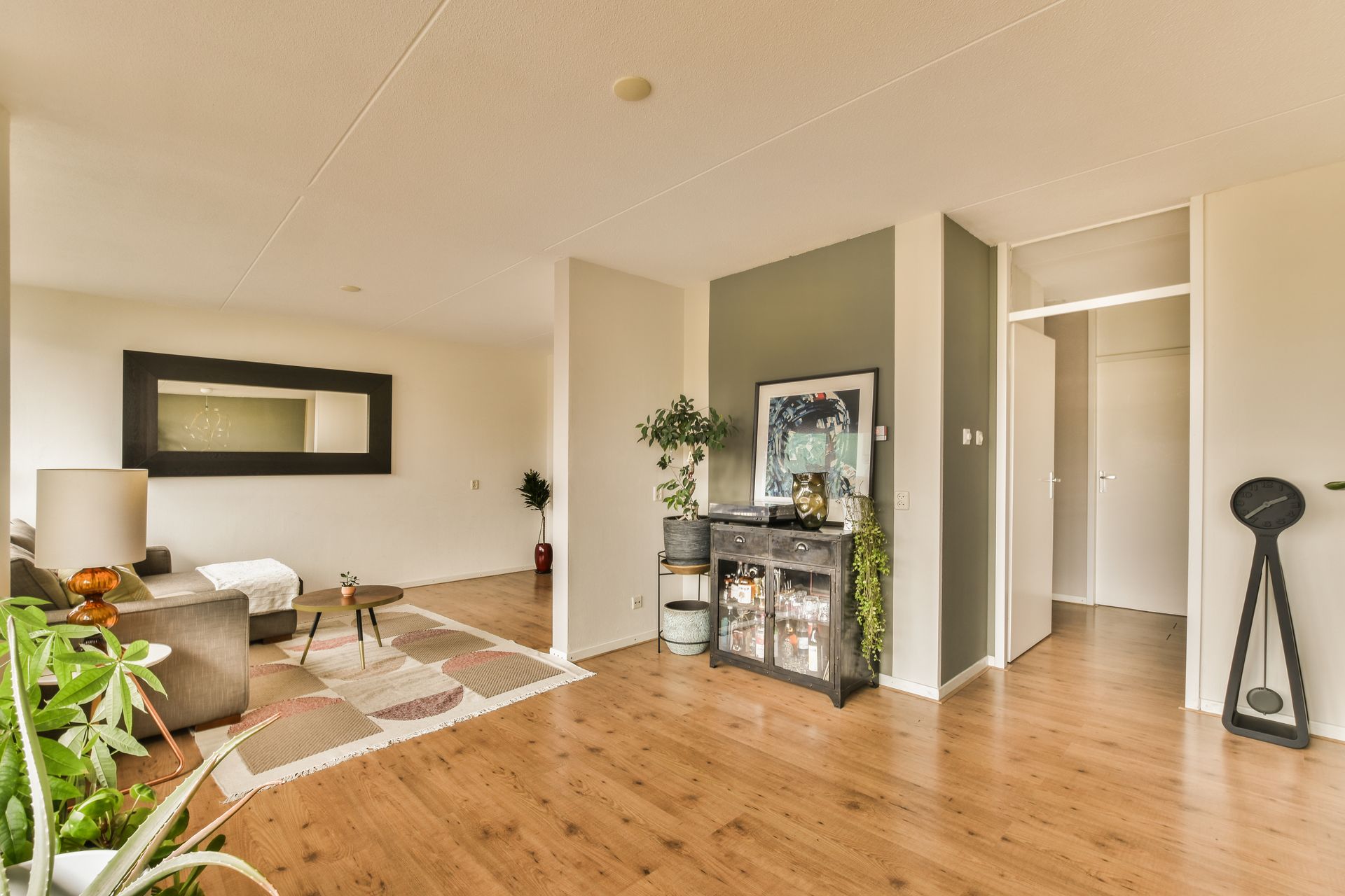 A living room with hardwood floors and a couch.