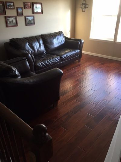 A living room with a couch and two chairs