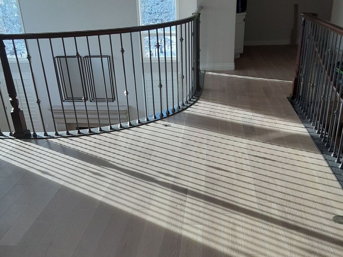 A person is installing a wooden floor in a room.