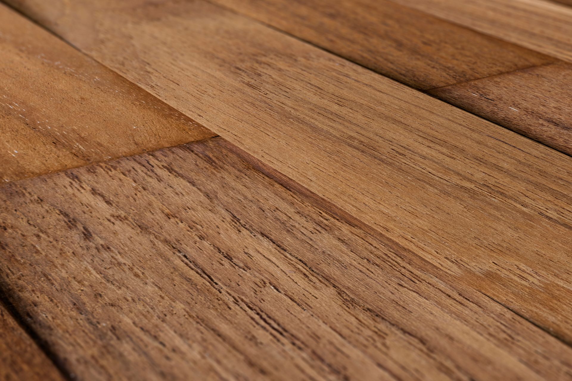 Close-up of a warm-toned wooden surface with visible grain and planks