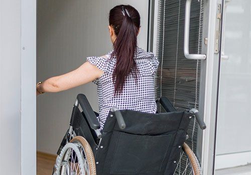 Handicap Doors — A PWD Woman Entering A Door in Boston, MA