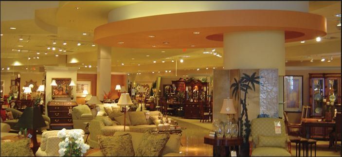 Interior of a furniture store. Sofas, lamps, and other furniture are on display.