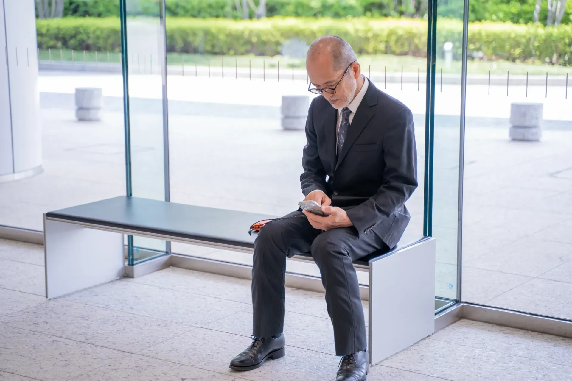 A person is holding a pineapple in a bag in a grocery store.