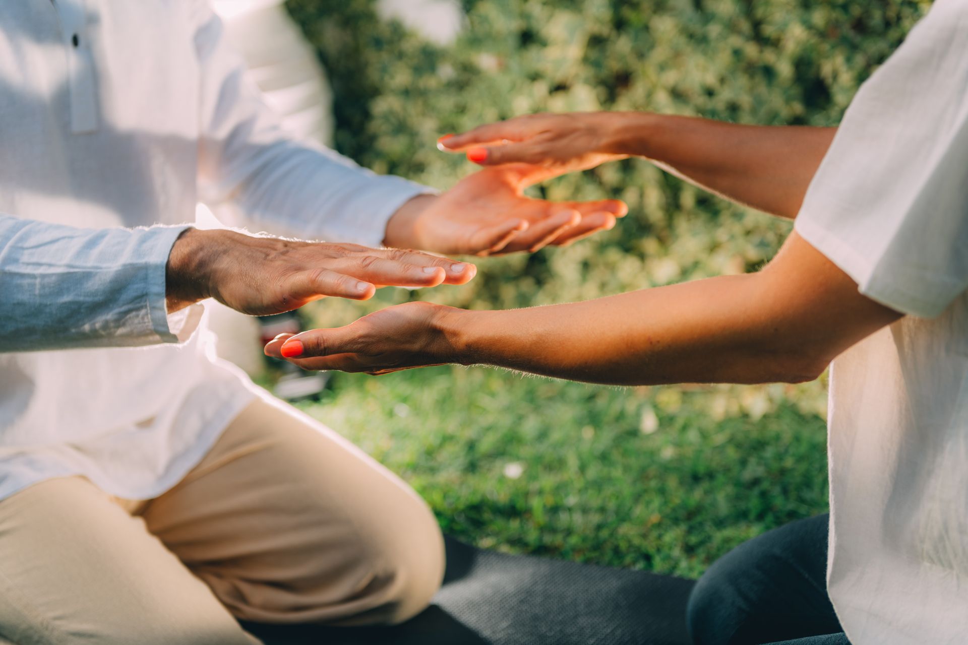 A man and a woman are holding hands in a park.