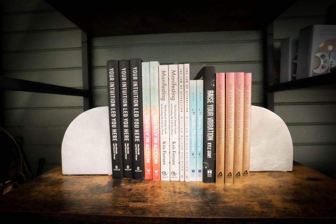 A row of colorful yoga mats sitting on top of a wooden shelf.