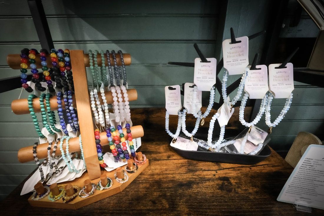 A display of bracelets and necklaces on a wooden table.