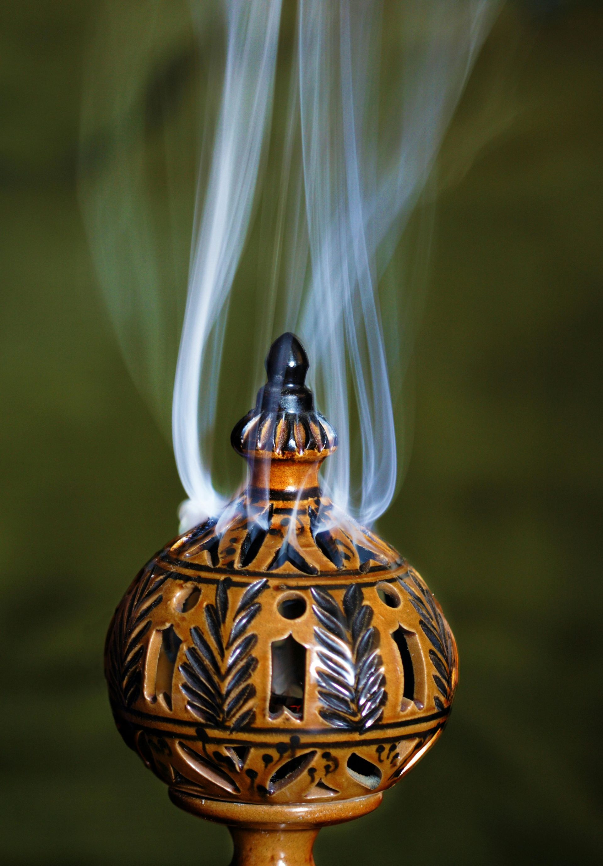 A candle holder with smoke coming out of it