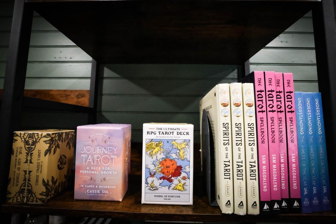 A bookshelf with tarot books on it