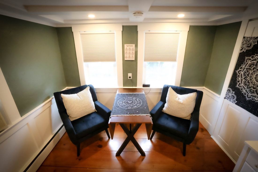 A room with two chairs and a table in it