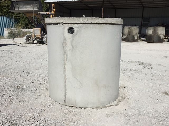 A concrete sink is being built in a hole in the ground