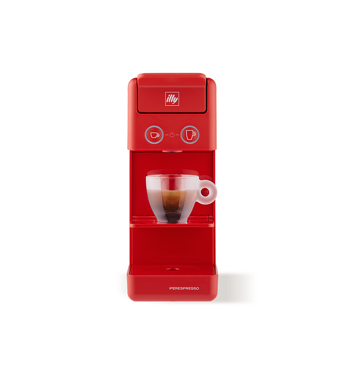 Macchina per caffè espresso Illy rossa con tazza di caffè in vetro.