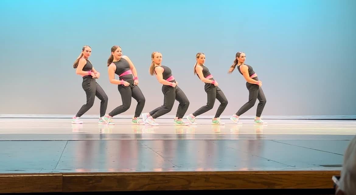 A group of young women are dancing on a stage.