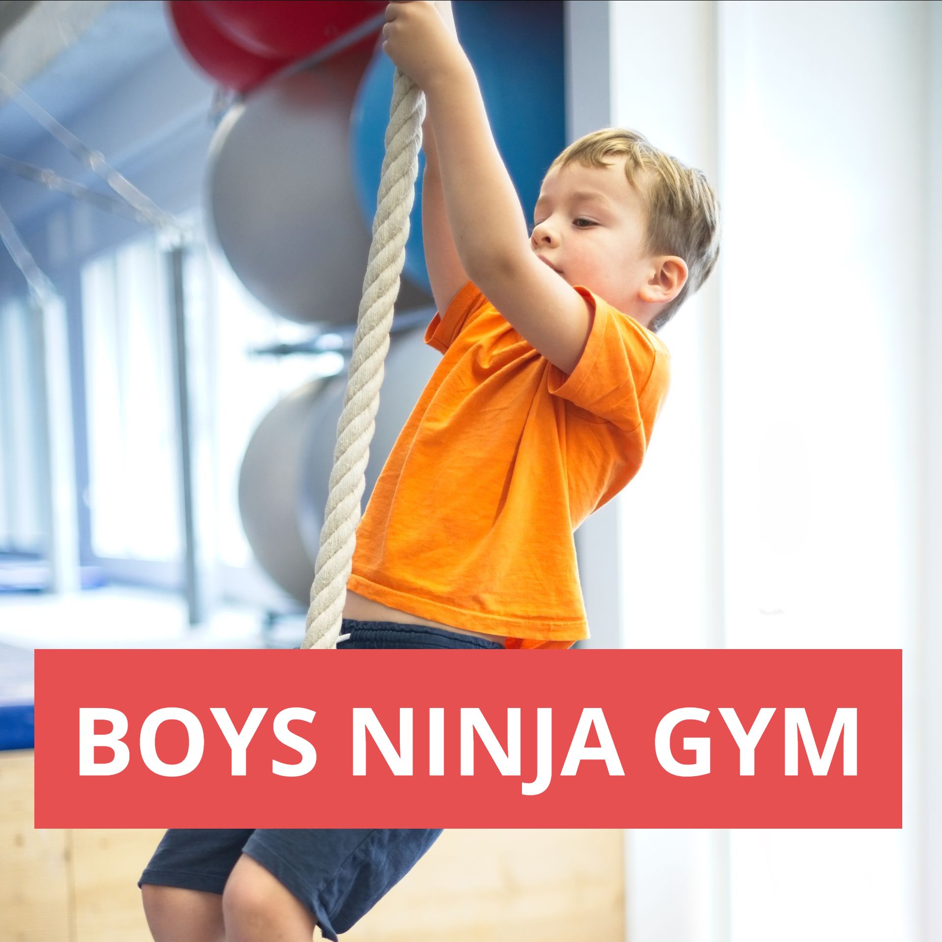 A young boy is climbing a rope in a boys ninja gym