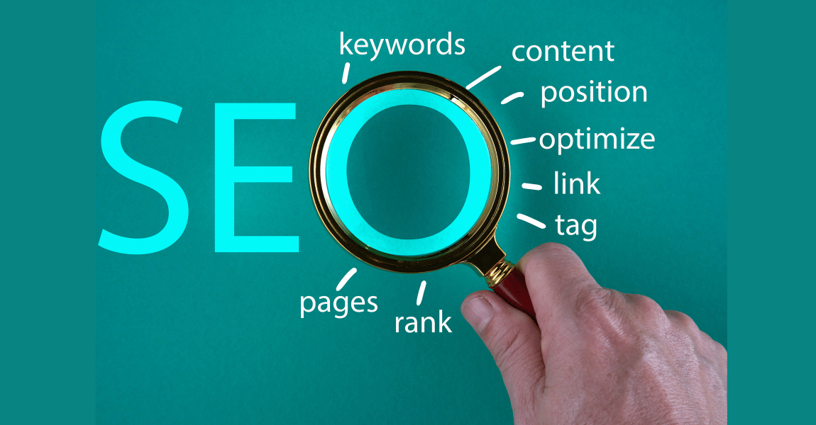 A hand is holding a magnifying glass over the word seo