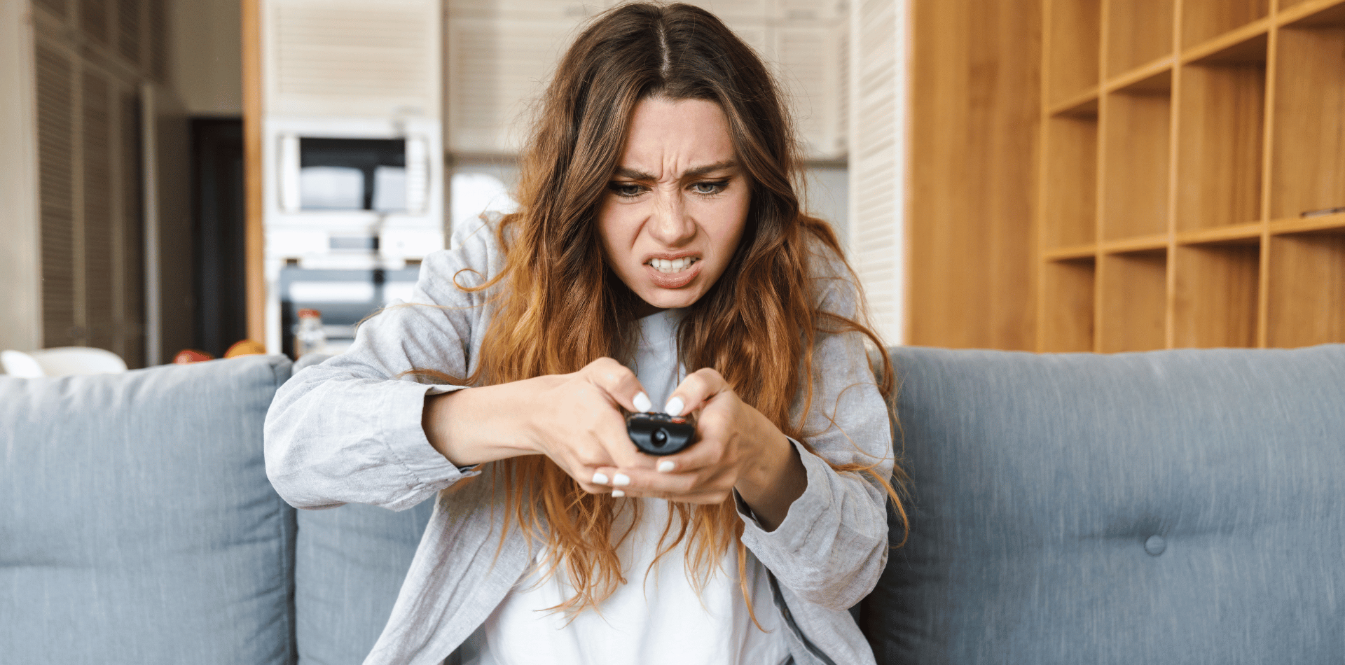 A woman being annoyed by TV advertising