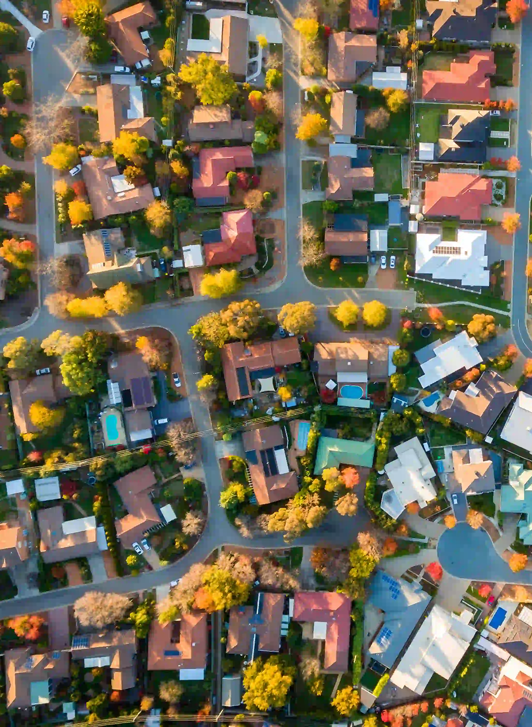 An aerial view of a residential area with lots of houses and trees.