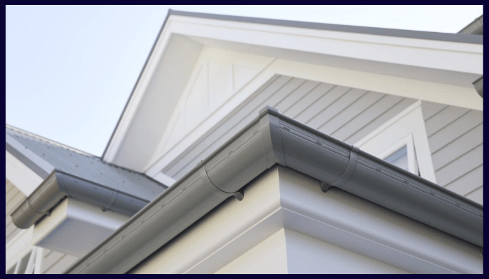 Close-up of Colorbond gutters and downpipes on a modern Canberra home.