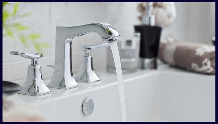 Modern low-flow bathroom tap running water in a Canberra home, illustrating water-efficient fixtures that help prevent drain blockages