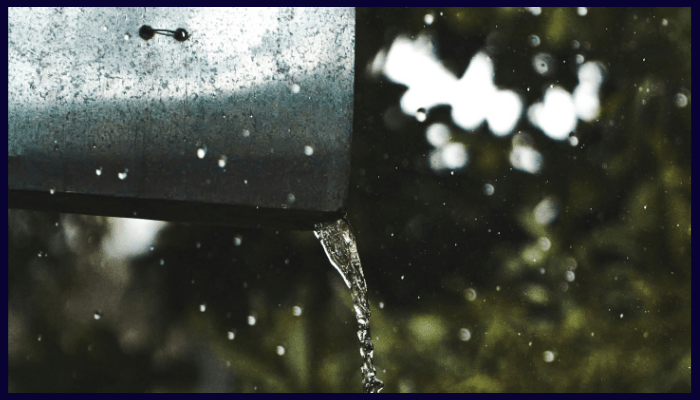 Rainwater flowing from a metal gutter during a storm in Canberra.
