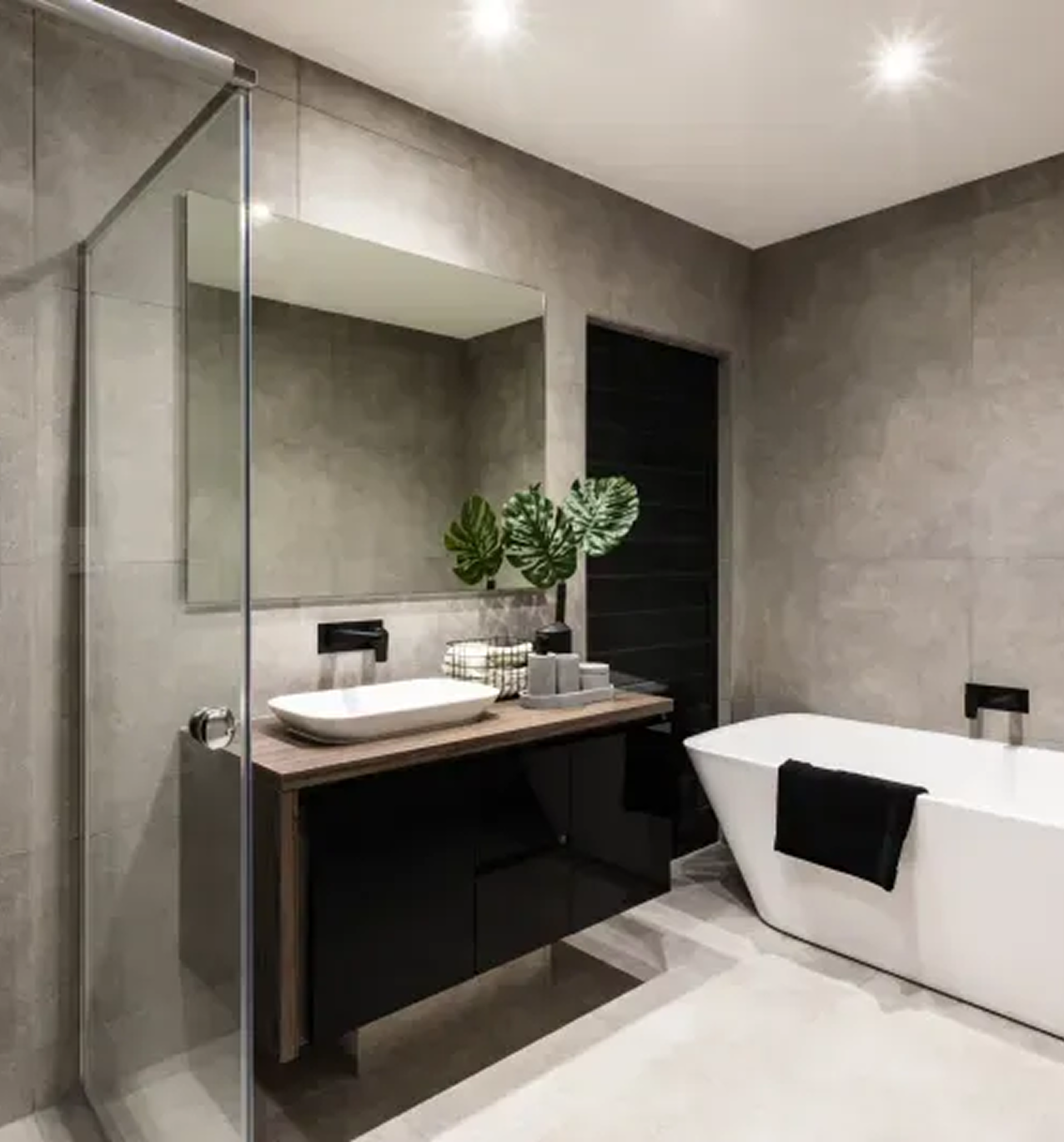 A bathroom with a tub , sink and mirror