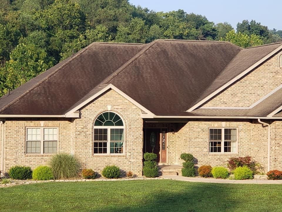 A large brick house with a brown roof