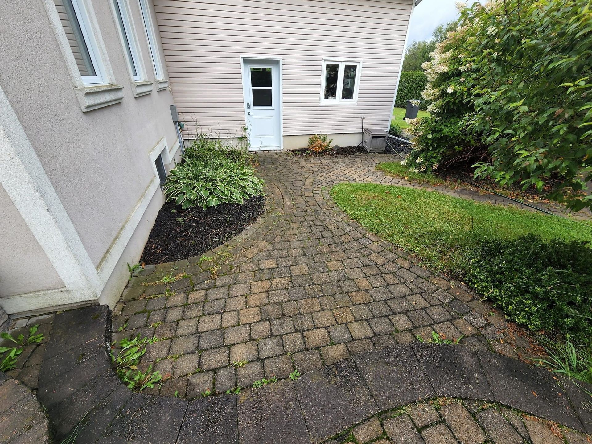 A before and after photo of a wooden deck with a white railing cleaned by sonic wash