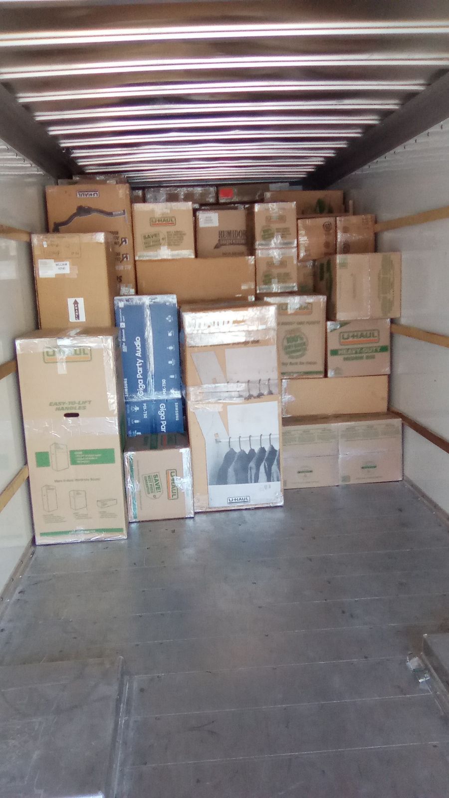 Boxes packed inside a truck, ready for transport.