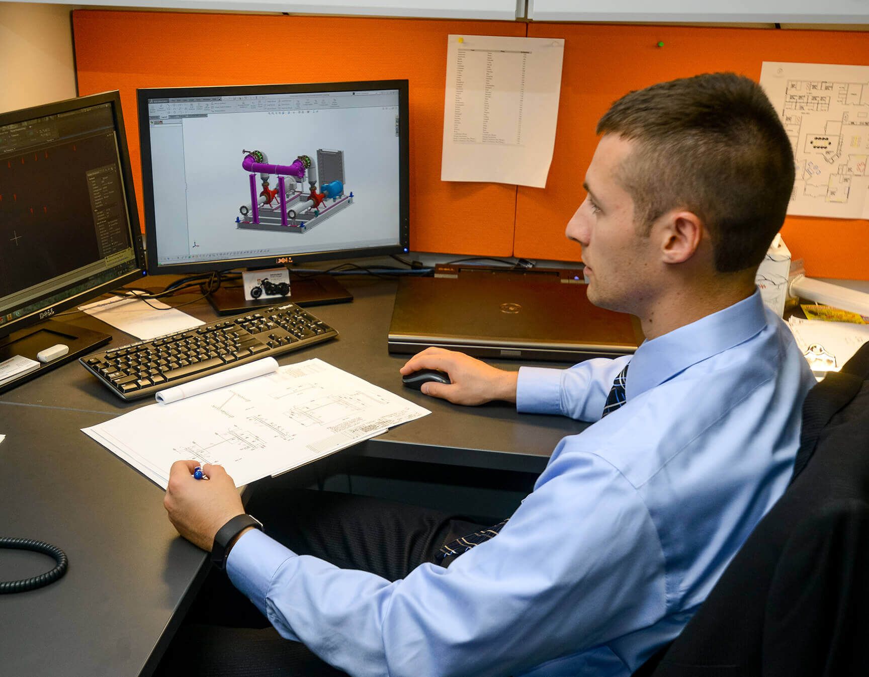 Ed Barth at his desk with CAD software on his computer