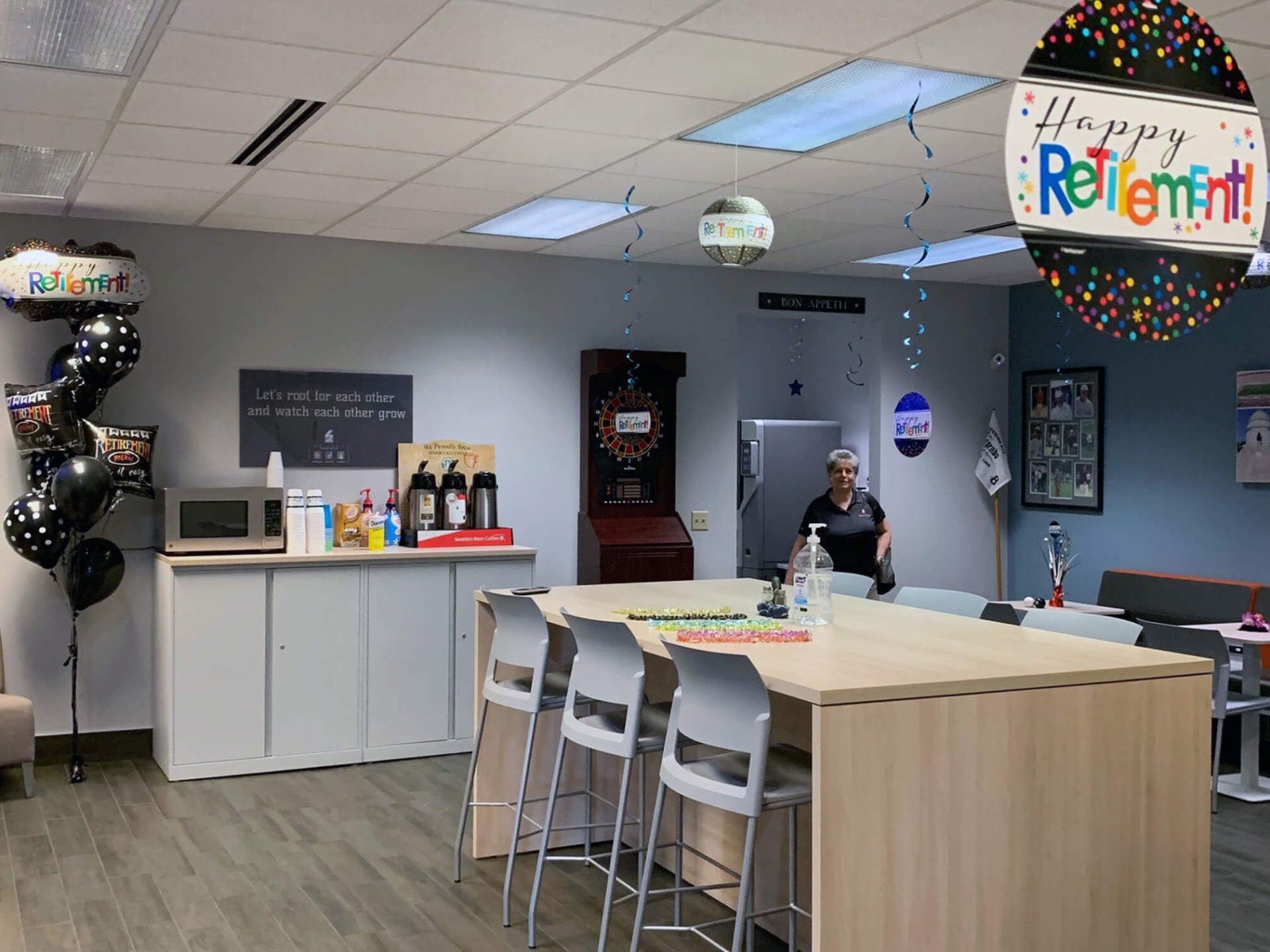 Grazyna in a break room decorated for her retirement party