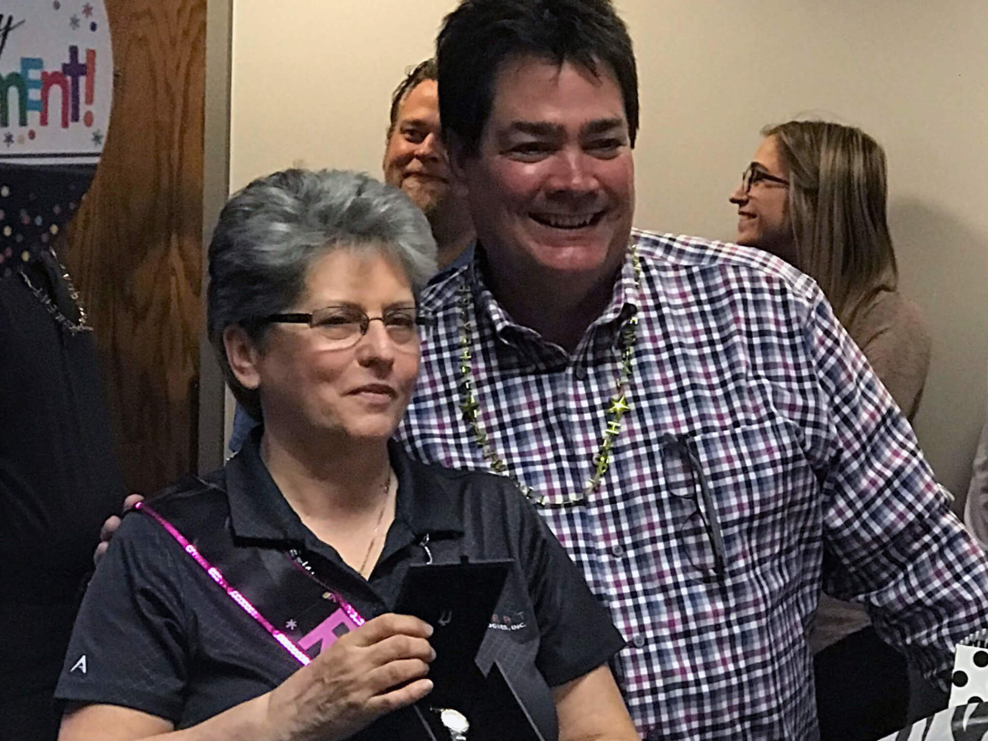 Grazyna surrounded by other employees