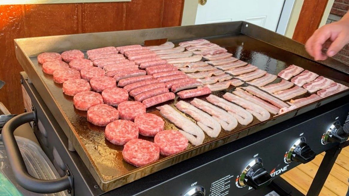 16 burgers, 26 hot dogs, and 33 slices of bacon on the griddle.