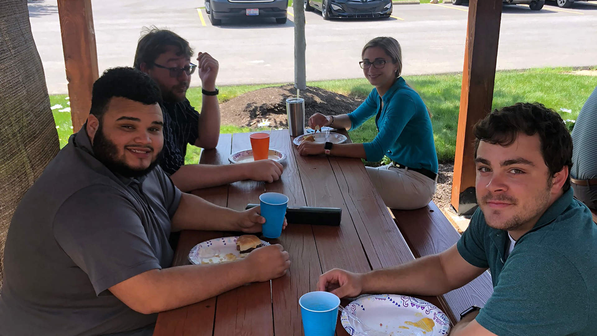 Four employees eating in in the pavilion