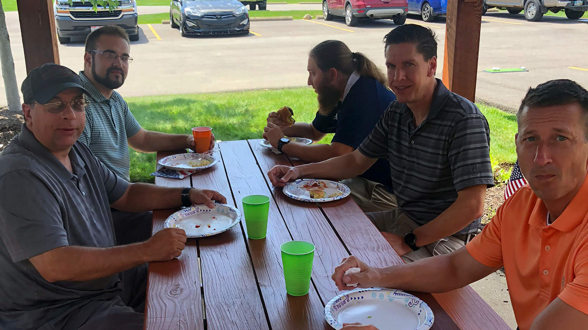 Five employees eating in in the pavilion