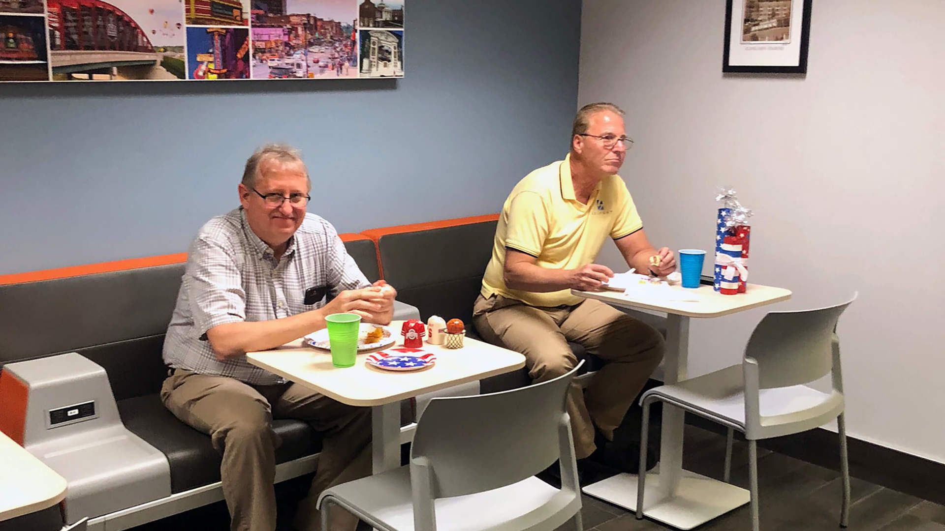 Two employees eating in the lunchroom