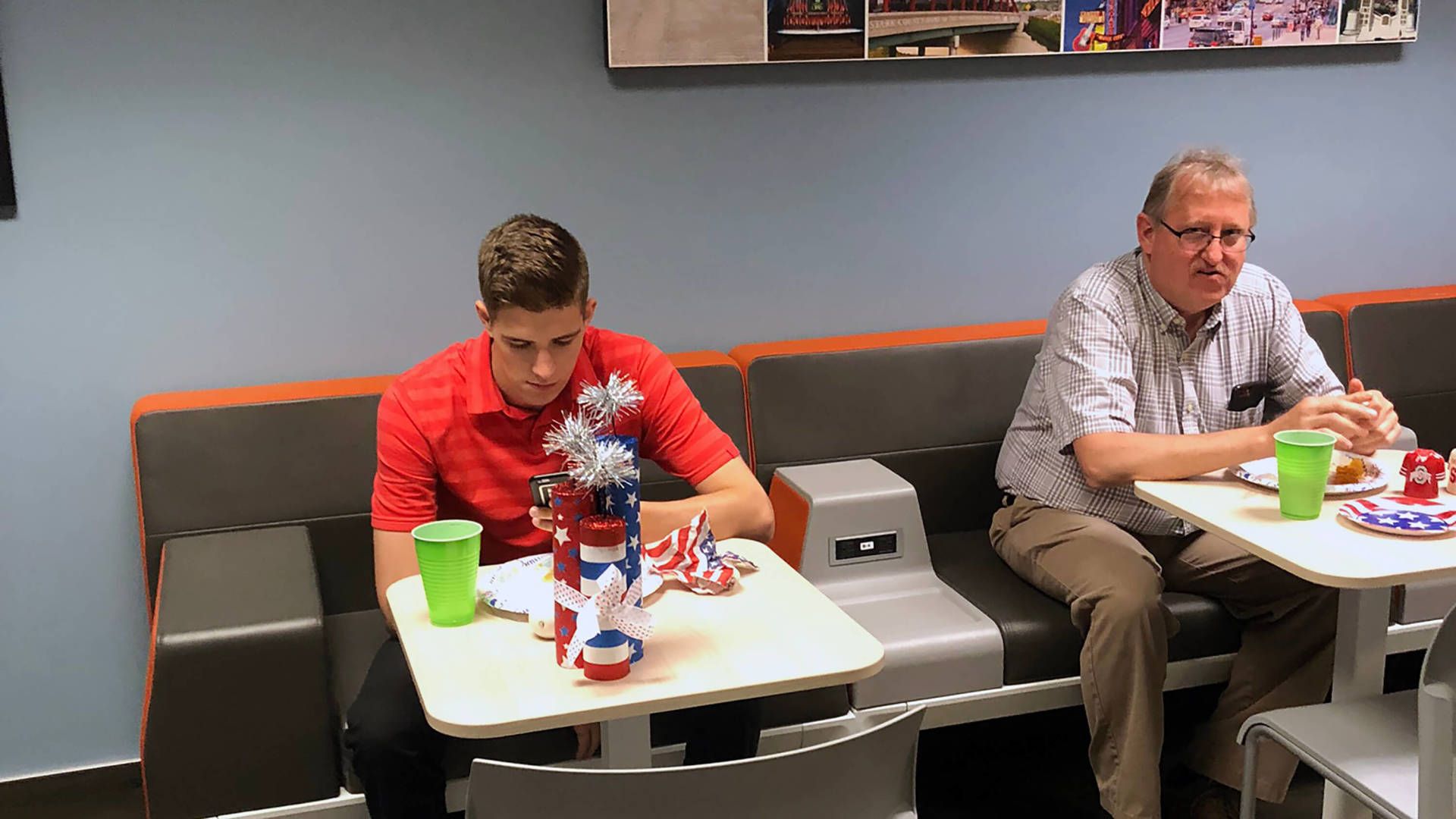Two employees eating in the lunchroom