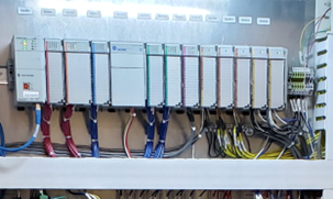 A line of PLC components in a panel box.