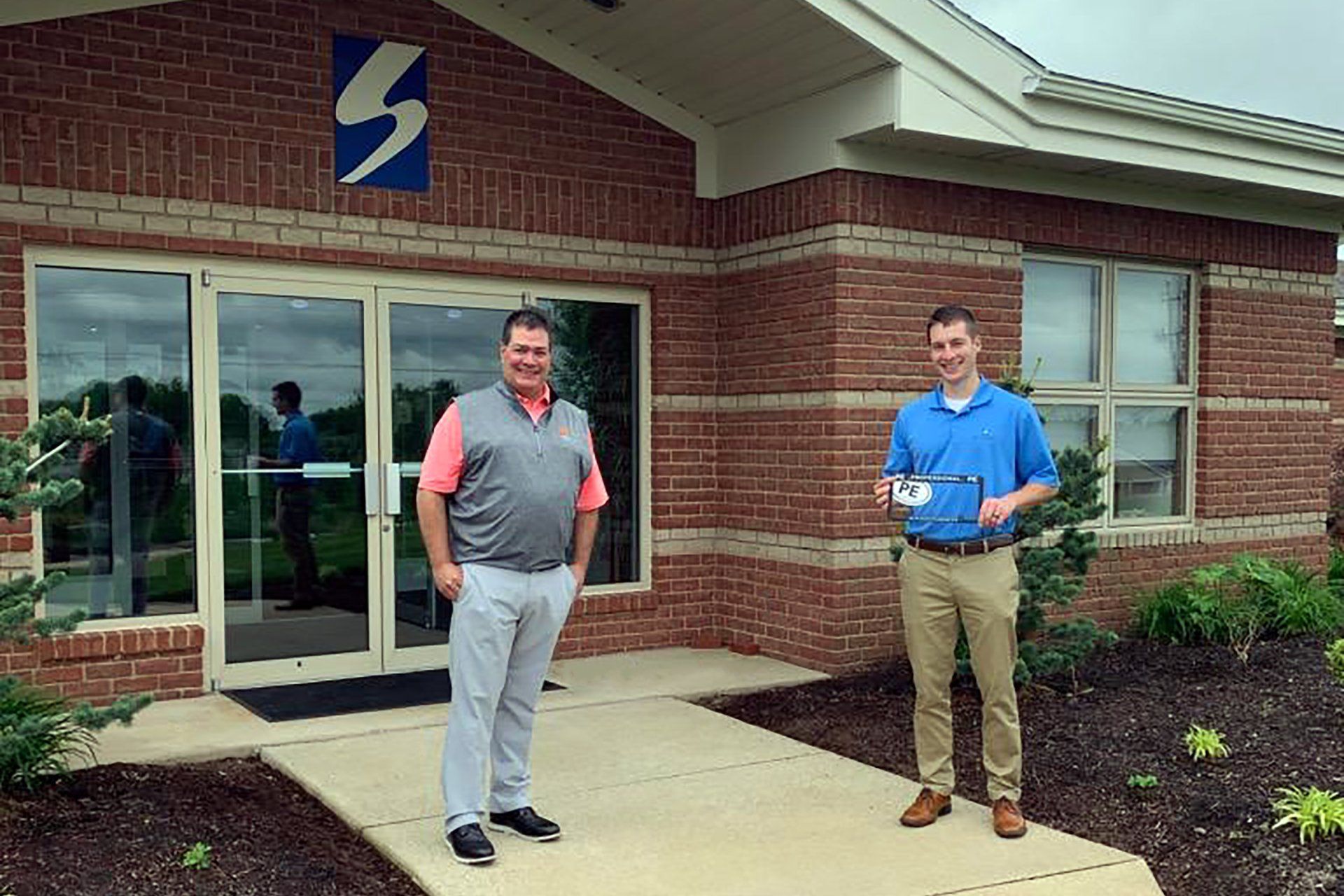 Tim Seifert and Ed Barth in front of Seifert building