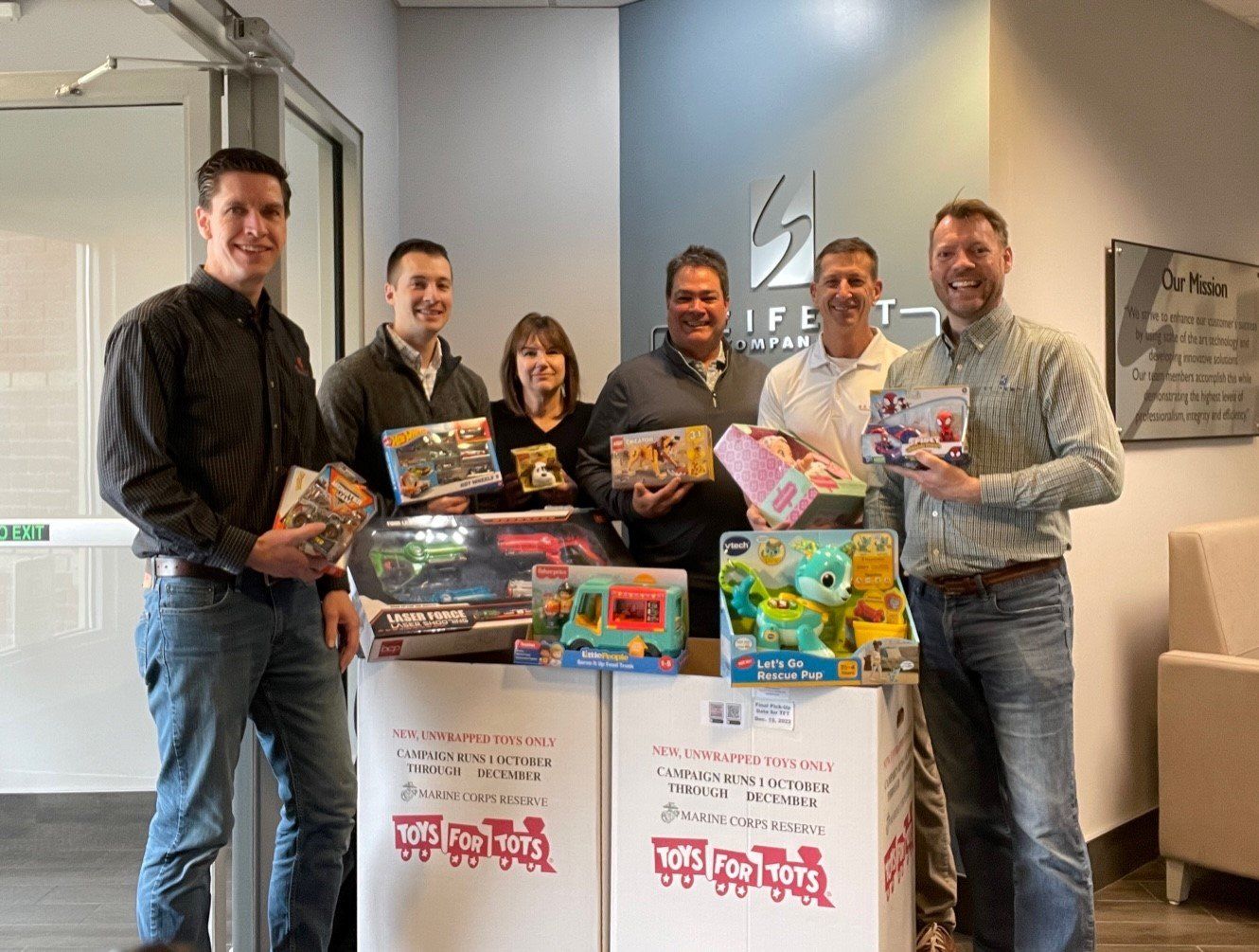 Carl, Ed, Angela Tim, Doug and Eric shown with Toys for Toys for Tots