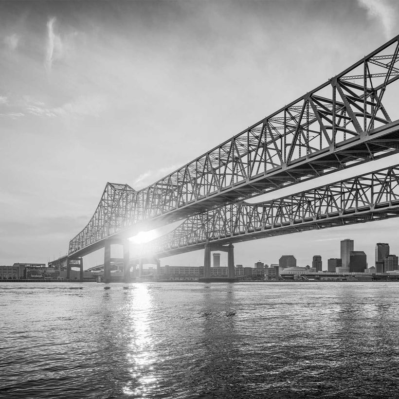 A black and white photo of a bridge over a body of water