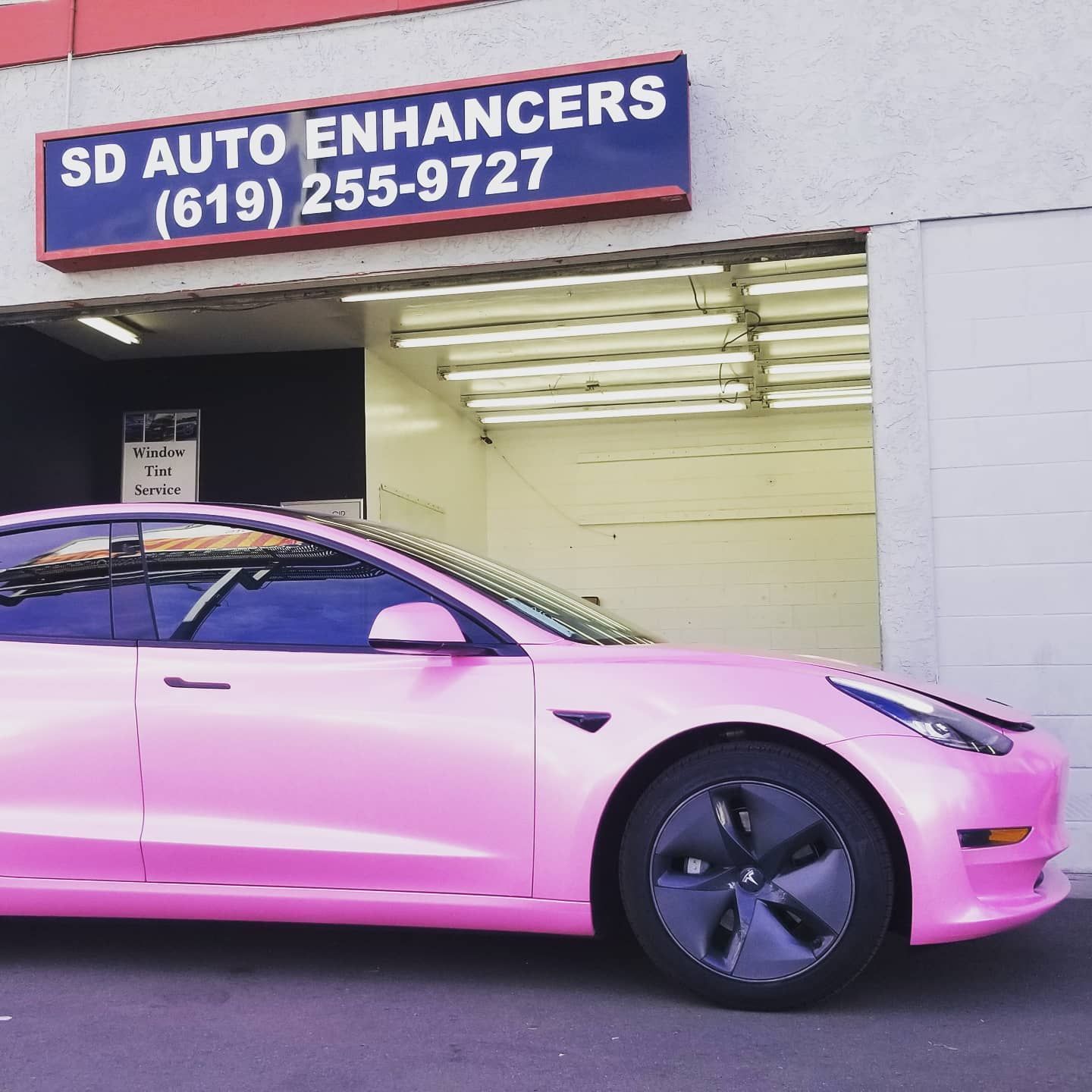 Pink Tesla car wrapped at SD Auto Enhancers shop.